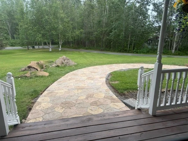 Curved stamped walkway from a porch across a lawn, photo from a Google review
